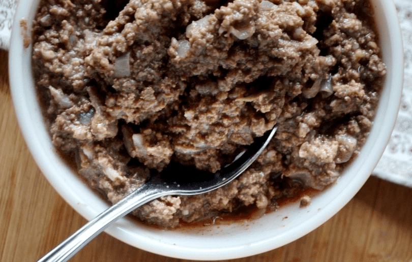 A delectable plate of traditional French meat stuffing, garnished with fresh herbs and served alongside roasted vegetables.