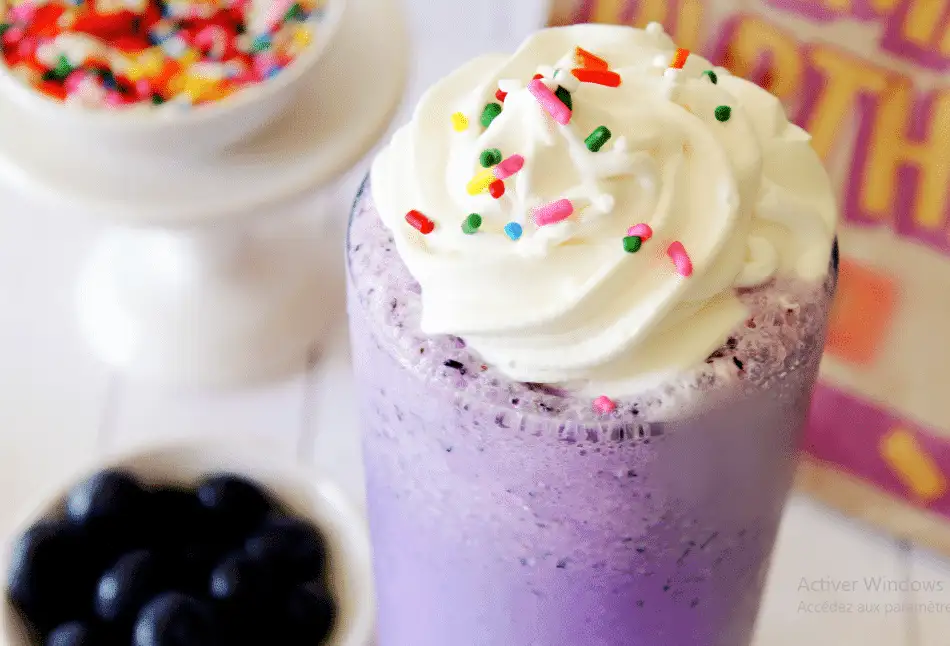 Homemade McDonald's Grimace Shake with whipped cream and sprinkles