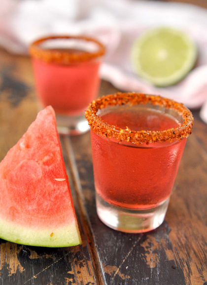 9 Proven Techniques for a Spectacular Mexican Candy Shot Recipe 1 A vibrant Mexican candy shot garnished with a rim of chili salt, accompanied by colorful traditional candies on the side.