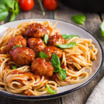 Delicious plate of bear spaghetti with rich sauce and fresh herbs.