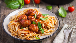 Delicious plate of bear spaghetti with rich sauce and fresh herbs.