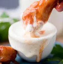 A bowl of creamy Wingstop Ranch dressing with fresh herbs