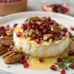 Baked brie with honey, nuts, and pomegranate